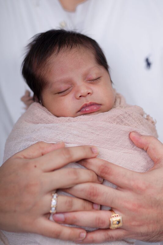The first child, held in muslin