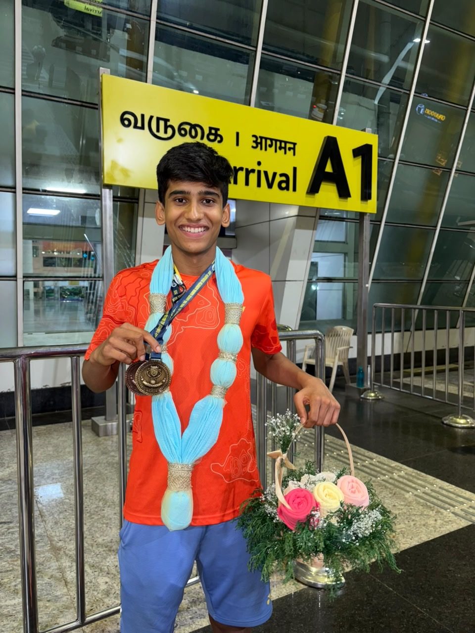 A national badminton champion welcomed home with a custom maala and bouquet