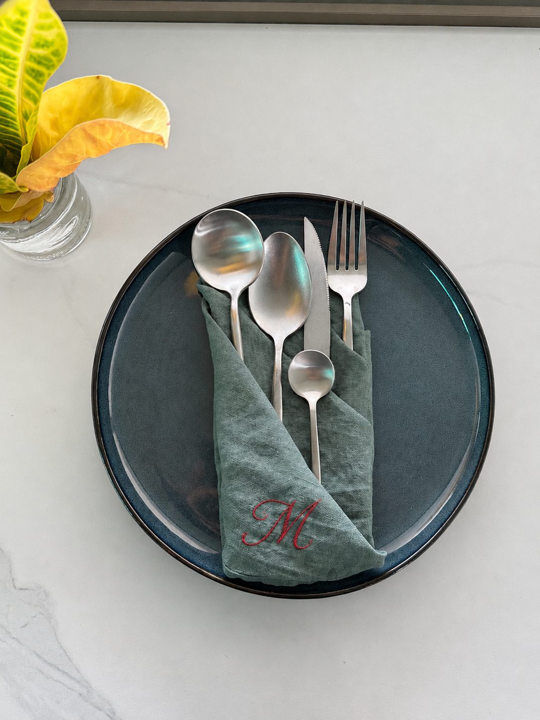 Monogrammed green napkin with red M monogram